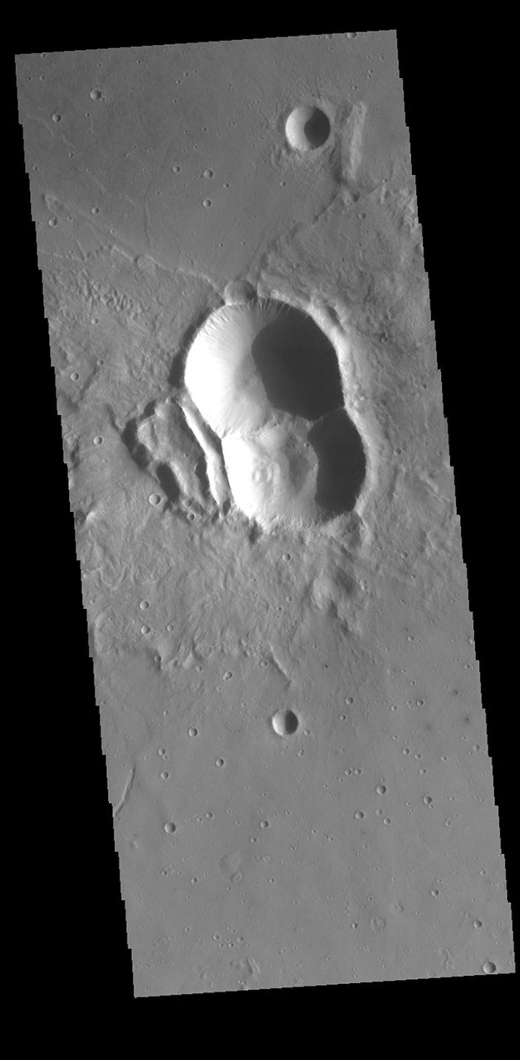This image from NASA's Mars Odyssey shows a crater from a double impact - two meteors hitting simultaneously. The two meteors would have started as a single object and, at some point prior to impact, separated into two parts.
