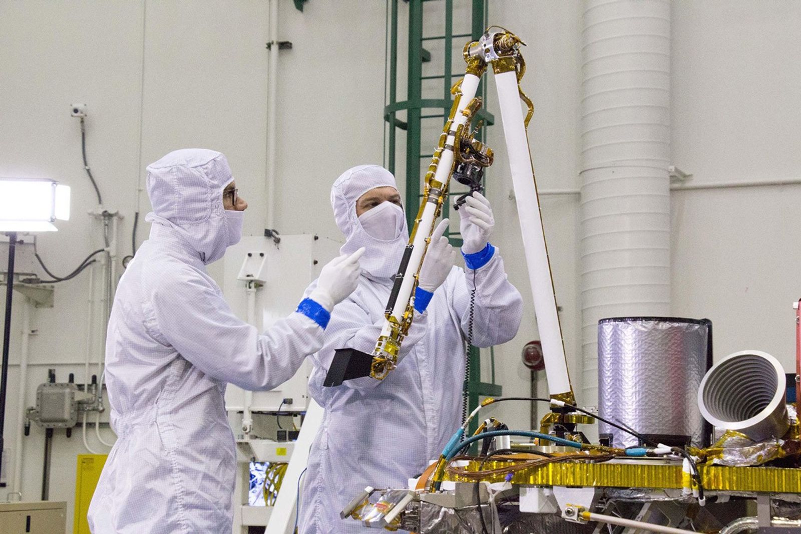 Engineers at Lockheed Martin Space, Denver, Colorado, test the robotic arm on NASA's InSight lander several months before launch.