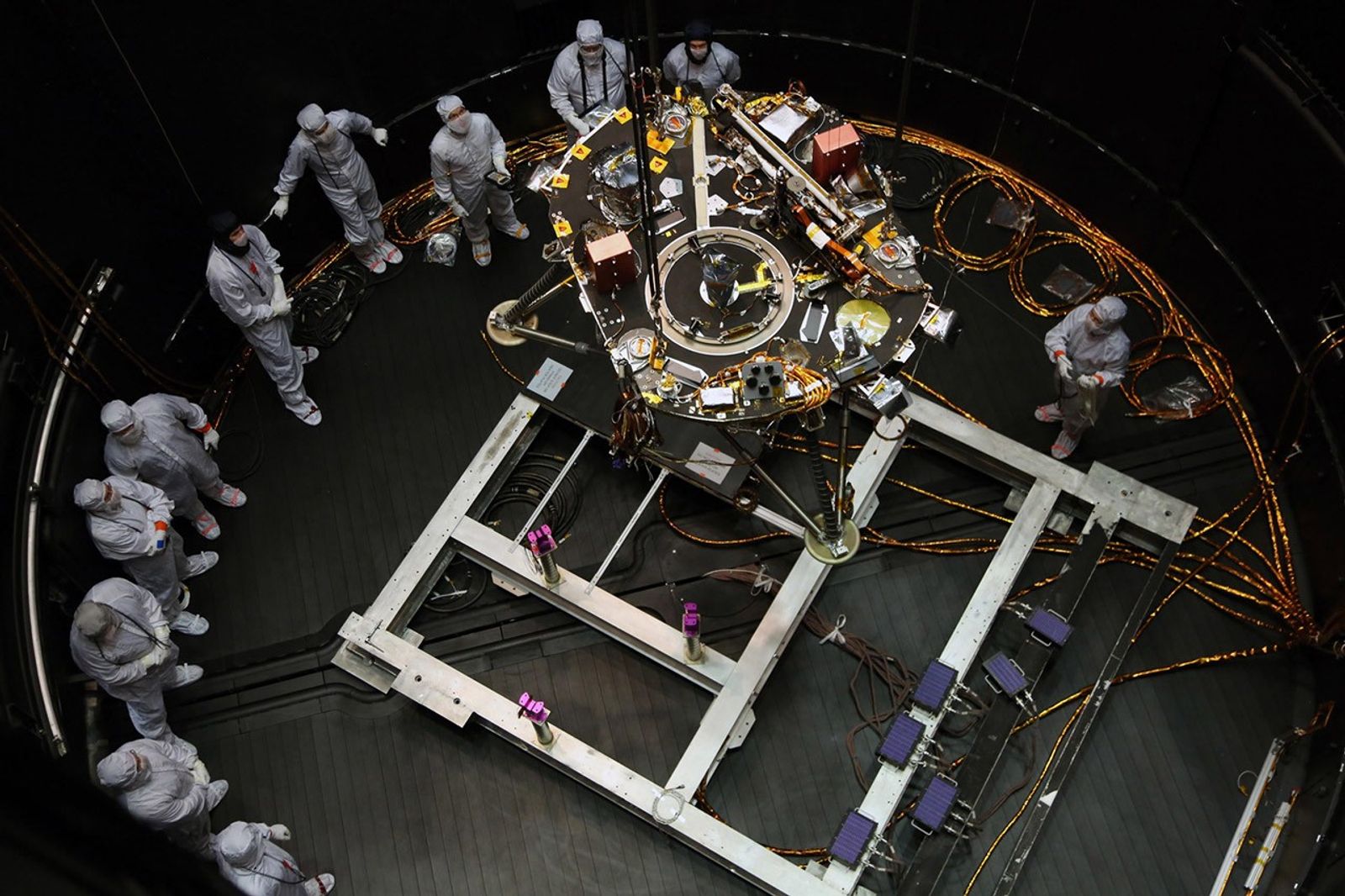 Engineers at Lockheed Martin Space, Denver, Colorado, prepare NASA's InSight lander for testing in a thermal vacuum chamber several months before launch.