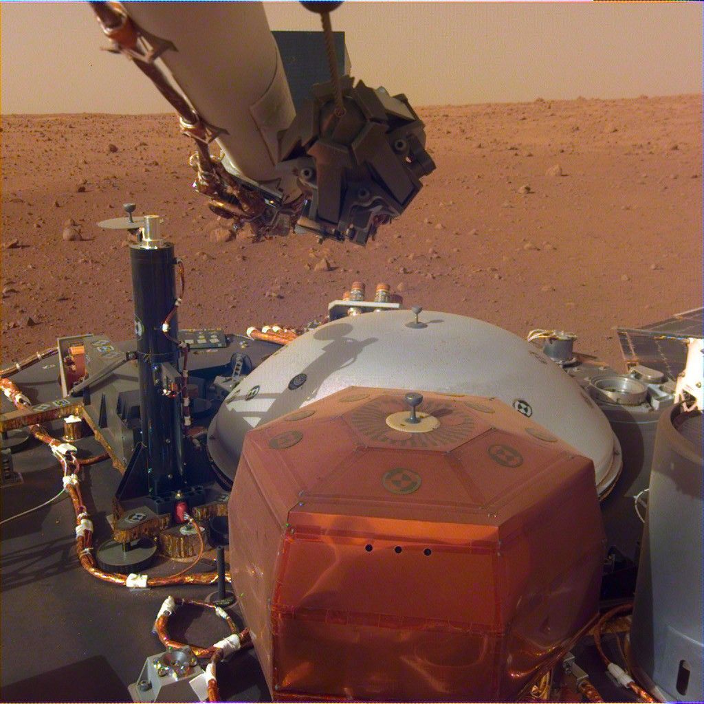 This image from InSight's robotic-arm mounted Instrument Deployment Camera shows the instruments on the spacecraft's deck, with the Martian surface of Elysium Planitia in the background. The image was received on Dec. 4, 2018 (Sol 8).