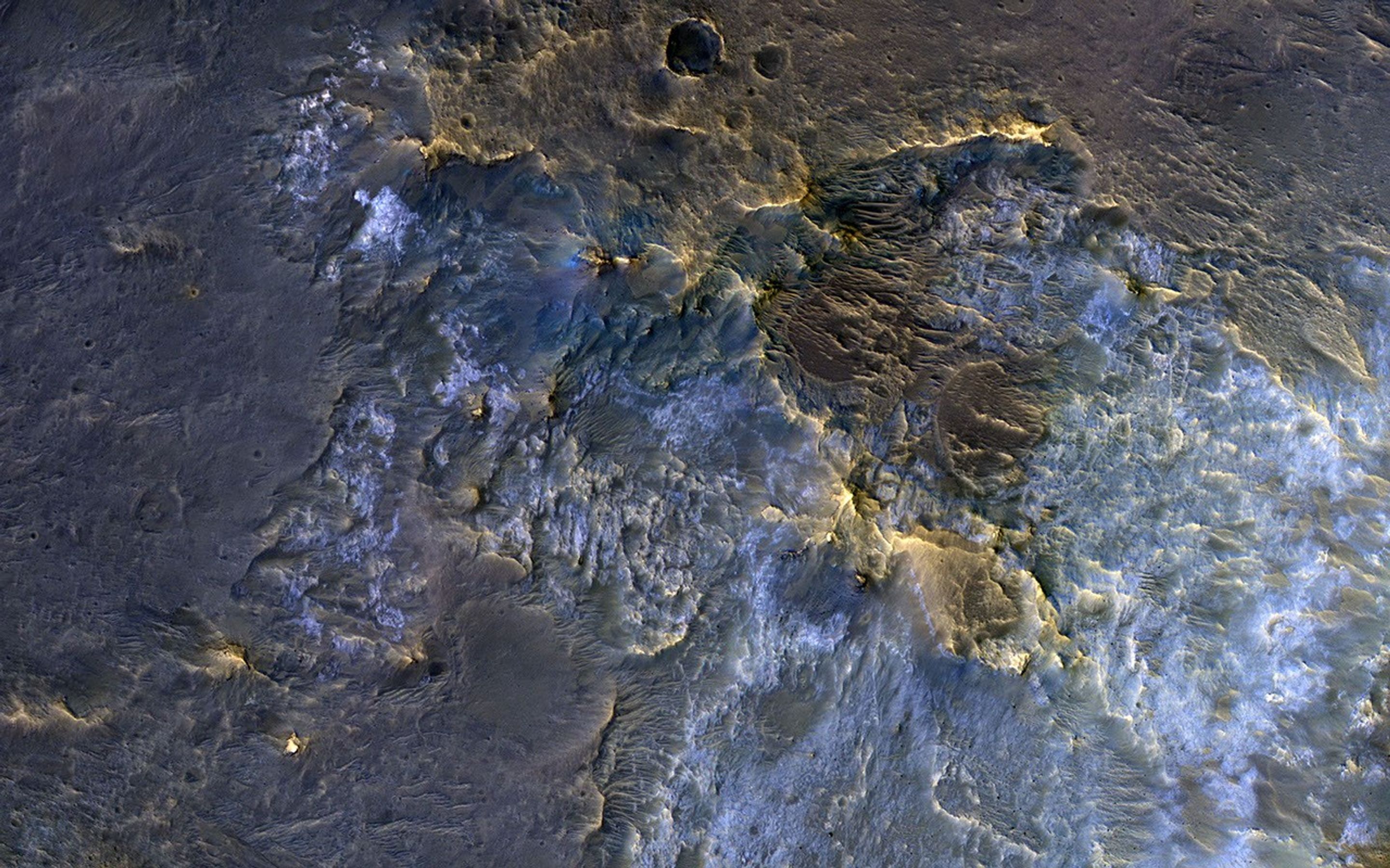This image acquired on November 30, 2018 by NASAs Mars Reconnaissance Orbiter, shows a complex crater, where we see bedrock in several locations from different depths in the crust.
