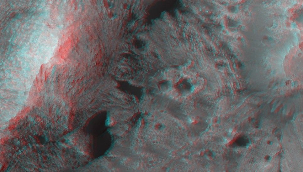 This image shows layered blocks tilted at high angles, diverse color and textures and dark dunes.
