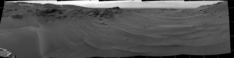 NASA's Mars rover Curiosity took 5 images in Gale Crater using its mast-mounted Left Navigation Camera (Navcam) to create this mosaic. The seam-corrected mosaic provides a 164-degree cylindrical projection panorama of the Martian surface centered at 279 degrees azimuth (measured clockwise from north). Curiosity took the images on April 17, 2015, Sol 957 of the Mars Science Laboratory mission at drive 934, site number 46. The local mean solar time for the image exposures was 3 PM. Each Navcam image has a 45 degree field of view. CREDIT: NASA/JPL-Caltech