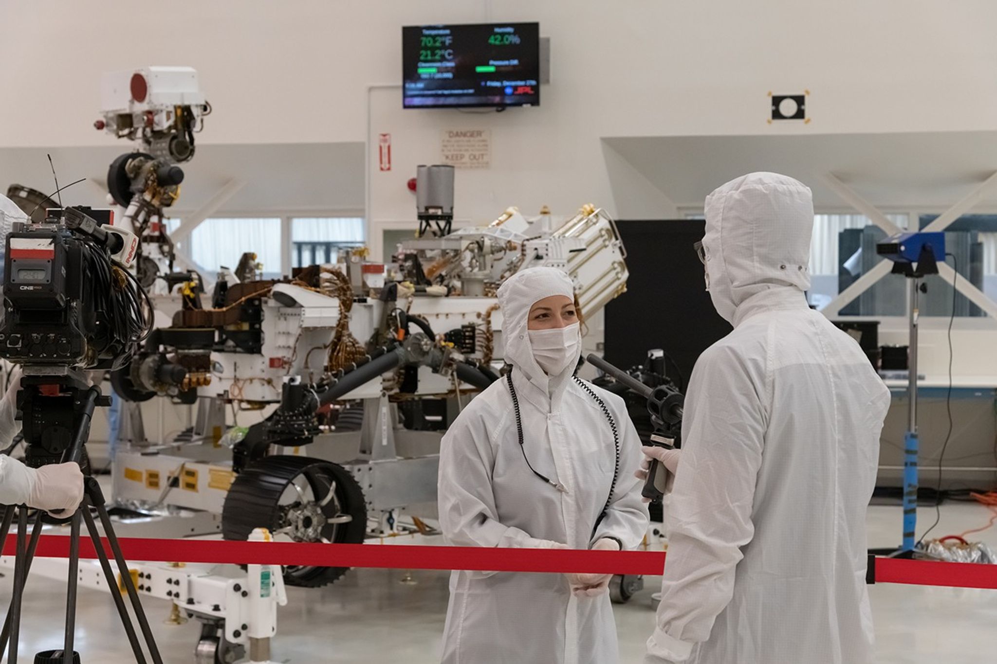 A member of the media interviews mission team member Jessica Samuels inside JPL’s High Bay 1 clean room on Dec. 27, 2019, during Mars 2020 media day.