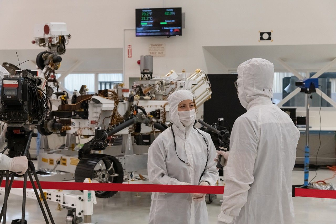 A member of the media interviews mission team member Jessica Samuels inside JPL’s High Bay 1 clean room on Dec. 27, 2019, during Mars 2020 media day.