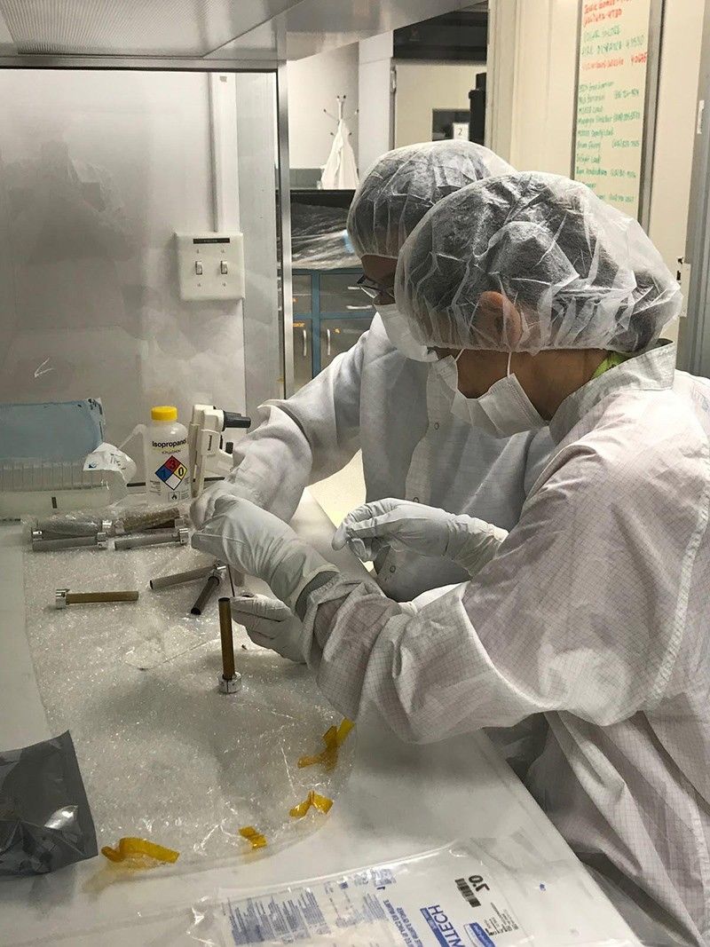 Engineers clean the tubes that will store Martian rock
