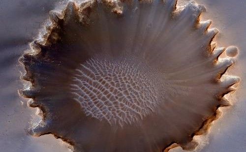 This image of Victoria Crater in the Meridiani Planum region of Mars was taken by the High Resolution Imaging Science Experiment (HiRISE) camera on NASA's Mars Reconnaissance Orbiter at more of a sideways angle than earlier orbital images of this crater.