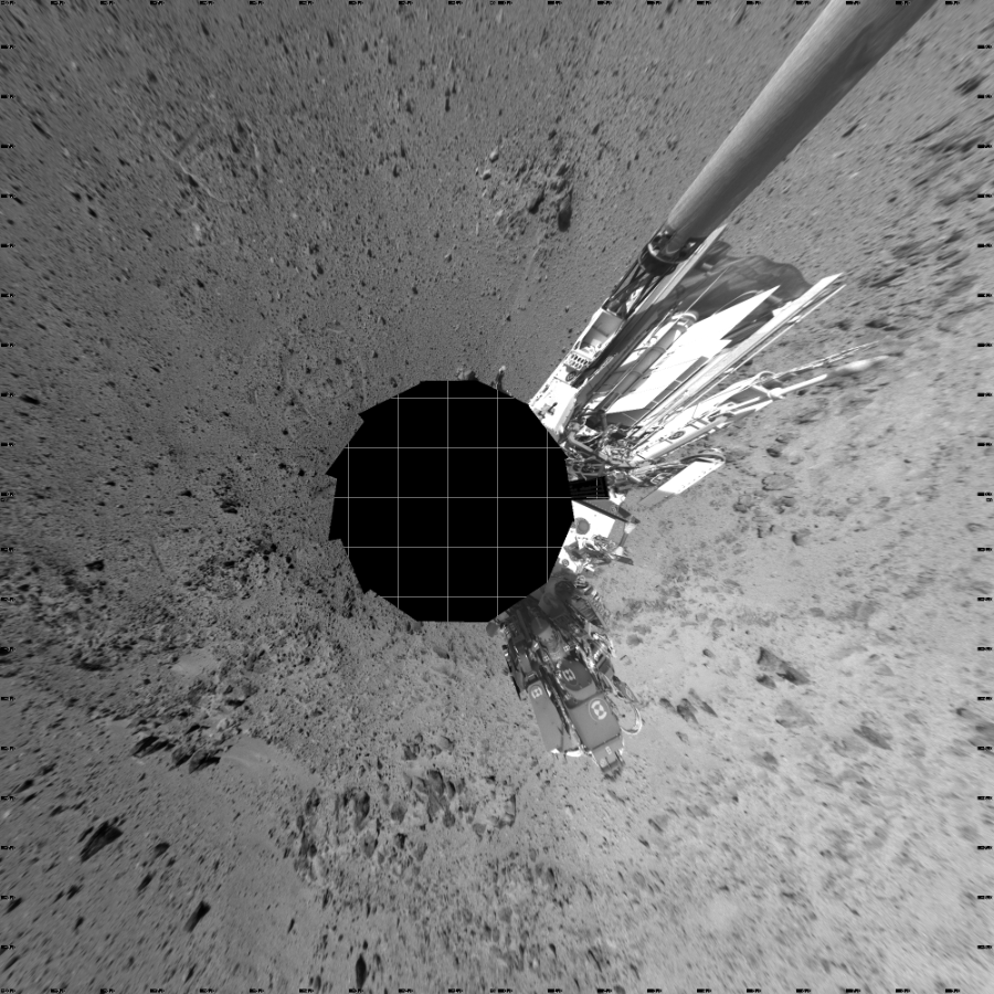 NASA's Mars rover Curiosity took 12 images in Gale Crater using its mast-mounted Left Navigation Camera (Navcam) to create this mosaic. The seam-corrected mosaic provides a vertical projection of the Martian surface near the rover, covering an area of 20 meters (north/south) by 20 meters (east/west). North is up in the image. This projection provides an overhead view, but introduces distortion for items not on the surface, such as large rocks and the rover itself.  Curiosity took the images on November 16, 2013, Sol 454 of the Mars Science Laboratory mission at drive 0, site number 23. The local mean solar time for the image exposures was from 2 PM to 3 PM. Each Navcam image has a 45-degree field of view. CREDIT: NASA/JPL-Caltech