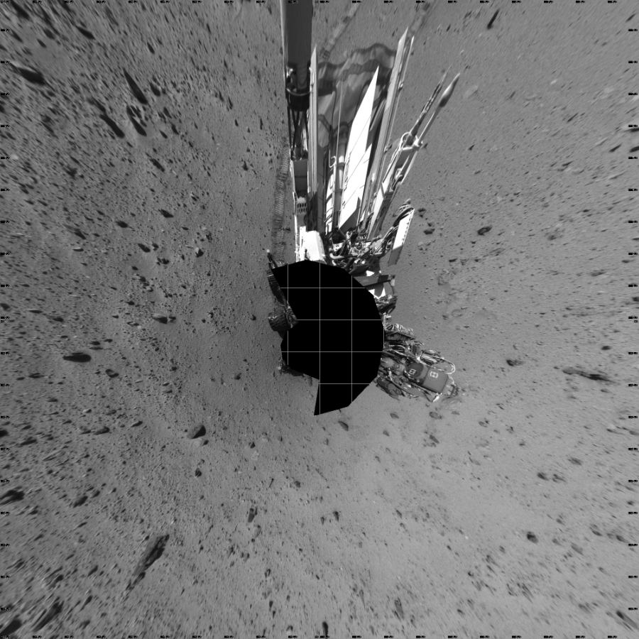 NASA's Mars rover Curiosity took 17 images in Gale Crater using its mast-mounted Left Navigation Camera (Navcam) to create this mosaic. The seam-corrected mosaic provides a vertical projection of the Martian surface near the rover, covering an area of 20 meters (north/south) by 20 meters (east/west). North is up in the image. This projection provides an overhead view, but introduces distortion for items not on the surface, such as large rocks and the rover itself.  Curiosity took the images on January 23, 2014, Sol 521 of the Mars Science Laboratory mission at drive 1296, site number 25. The local mean solar time for the image exposures was 2 PM. Each Navcam image has a 45-degree field of view. CREDIT: NASA/JPL-Caltech
