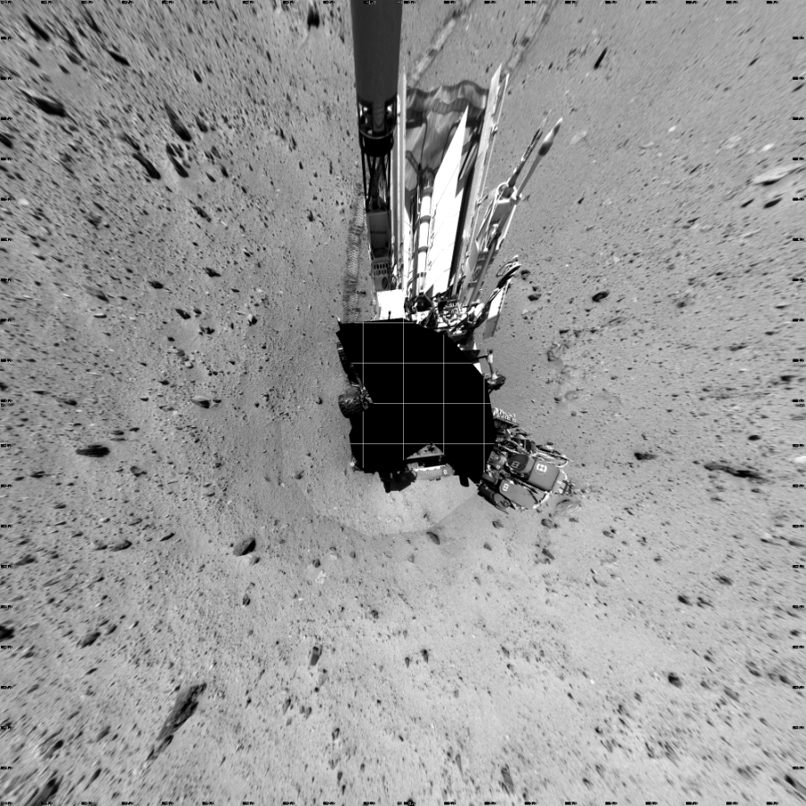NASA's Mars rover Curiosity took 19 images in Gale Crater using its mast-mounted Left Navigation Camera (Navcam) to create this mosaic. The seam-corrected mosaic provides a vertical projection of the Martian surface near the rover, covering an area of 20 meters (north/south) by 20 meters (east/west). North is up in the image. This projection provides an overhead view, but introduces distortion for items not on the surface, such as large rocks and the rover itself.  Curiosity took the images on January 24, 2014, Sol 522 of the Mars Science Laboratory mission at drive 1296, site number 25. The local mean solar time for the image exposures was from 1 PM to 12 PM. Each Navcam image has a 45-degree field of view. CREDIT: NASA/JPL-Caltech