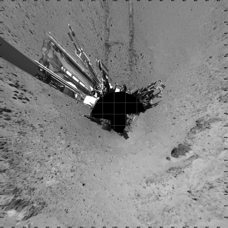 NASA's Mars rover Curiosity took 19 images in Gale Crater using its mast-mounted Left Navigation Camera (Navcam) to create this mosaic. The seam-corrected mosaic provides a vertical projection of the Martian surface near the rover, covering an area of 20 meters (north/south) by 20 meters (east/west). North is up in the image. This projection provides an overhead view, but introduces distortion for items not on the surface, such as large rocks and the rover itself.  Curiosity took the images on March 10, 2014, Sol 565 of the Mars Science Laboratory mission at drive 536, site number 29. The local mean solar time for the image exposures was 1 PM. Each Navcam image has a 45-degree field of view. CREDIT: NASA/JPL-Caltech