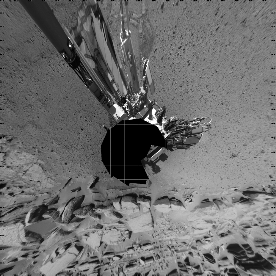 NASA's Mars rover Curiosity took 14 images in Gale Crater using its mast-mounted Left Navigation Camera (Navcam) to create this mosaic. The seam-corrected mosaic provides a vertical projection of the Martian surface near the rover, covering an area of 20 meters (north/south) by 20 meters (east/west). North is up in the image. This projection provides an overhead view, but introduces distortion for items not on the surface, such as large rocks and the rover itself.  Curiosity took the images on March 31, 2014, Sol 586 of the Mars Science Laboratory mission at drive 820, site number 30. The local mean solar time for the image exposures was 2 PM. Each Navcam image has a 45-degree field of view. CREDIT: NASA/JPL-Caltech