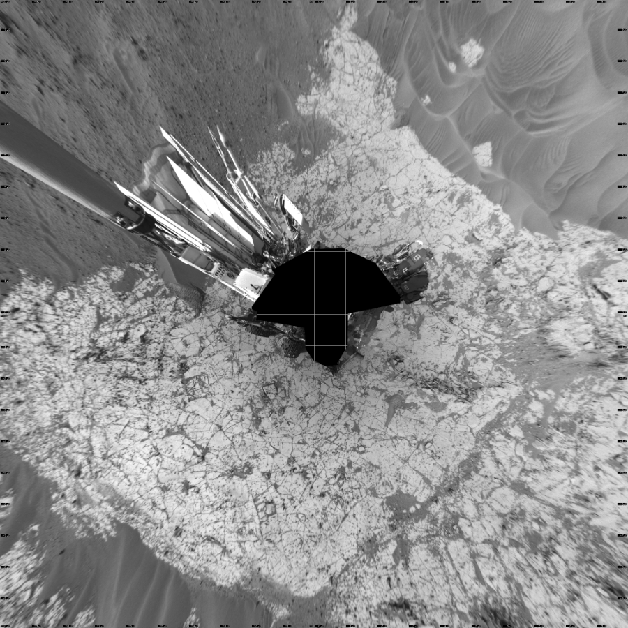 NASA's Mars rover Curiosity took 19 images in Gale Crater using its mast-mounted Left Navigation Camera (Navcam) to create this mosaic. The seam-corrected mosaic provides a vertical projection of the Martian surface near the rover, covering an area of 20 meters (north/south) by 20 meters (east/west). North is up in the image. This projection provides an overhead view, but introduces distortion for items not on the surface, such as large rocks and the rover itself.  Curiosity took the images on January 11, 2015, Sol 864 of the Mars Science Laboratory mission at drive 0, site number 45. The local mean solar time for the image exposures was 3 PM. Each Navcam image has a 45-degree field of view. CREDIT: NASA/JPL-Caltech