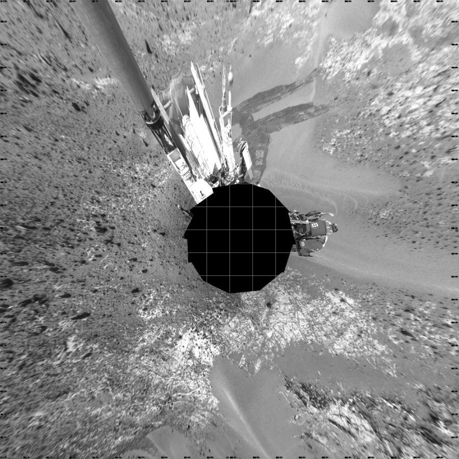 NASA's Mars rover Curiosity took 12 images in Gale Crater using its mast-mounted Left Navigation Camera (Navcam) to create this mosaic. The seam-corrected mosaic provides a vertical projection of the Martian surface near the rover, covering an area of 20 meters (north/south) by 20 meters (east/west). North is up in the image. This projection provides an overhead view, but introduces distortion for items not on the surface, such as large rocks and the rover itself. Curiosity took the images on March 14, 2015, Sol 924 of the Mars Science Laboratory mission at drive 774, site number 45. The local mean solar time for the image exposures was 2 PM. Each Navcam image has a 45-degree field of view. CREDIT: NASA/JPL-Caltech