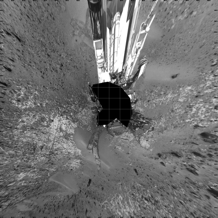 NASA's Mars rover Curiosity took 19 images in Gale Crater using its mast-mounted Left Navigation Camera (Navcam) to create this mosaic. The seam-corrected mosaic provides a vertical projection of the Martian surface near the rover, covering an area of 20 meters (north/south) by 20 meters (east/west). North is up in the image. This projection provides an overhead view, but introduces distortion for items not on the surface, such as large rocks and the rover itself.  Curiosity took the images on April 03, 2015, Sol 944 of the Mars Science Laboratory mission at drive 1108, site number 45. The local mean solar time for the image exposures was 2 PM. Each Navcam image has a 45-degree field of view. CREDIT: NASA/JPL-Caltech