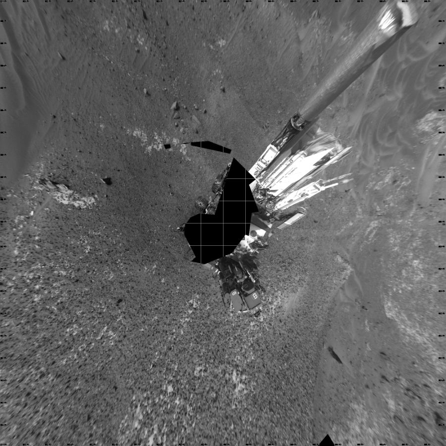 NASA's Mars rover Curiosity took 17 images in Gale Crater using its mast-mounted Left Navigation Camera (Navcam) to create this mosaic. The seam-corrected mosaic provides a vertical projection of the Martian surface near the rover, covering an area of 20 meters (north/south) by 20 meters (east/west). North is up in the image. This projection provides an overhead view, but introduces distortion for items not on the surface, such as large rocks and the rover itself.  Curiosity took the images on May 20, 2015, Sol 990 of the Mars Science Laboratory mission at drive 876, site number 48. The local mean solar time for the image exposures was from 2 PM to 3 PM. Each Navcam image has a 45-degree field of view. CREDIT: NASA/JPL-Caltech