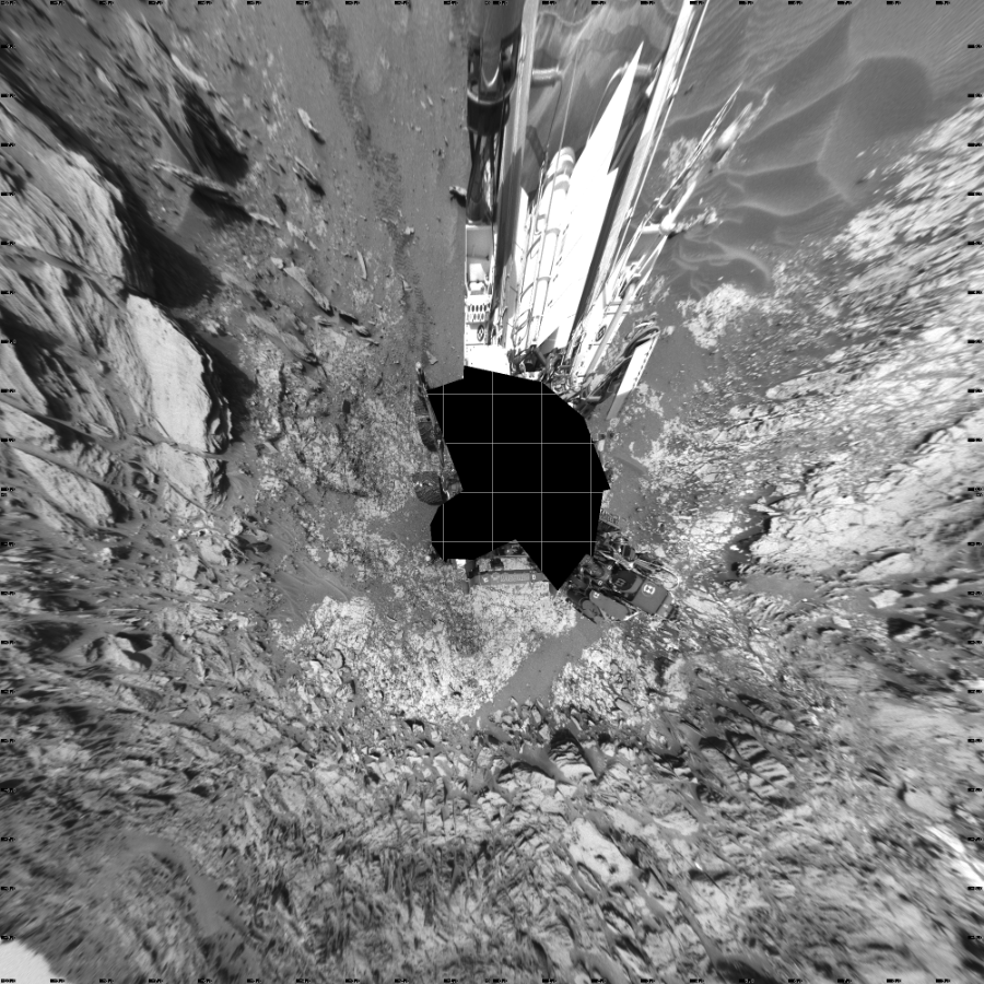 NASA's Mars rover Curiosity took 19 images in Gale Crater using its mast-mounted Left Navigation Camera (Navcam) to create this mosaic. The seam-corrected mosaic provides a vertical projection of the Martian surface near the rover, covering an area of 20 meters (north/south) by 20 meters (east/west). North is up in the image. This projection provides an overhead view, but introduces distortion for items not on the surface, such as large rocks and the rover itself.  Curiosity took the images on May 26, 2015, Sol 995 of the Mars Science Laboratory mission at drive 1530, site number 48. The local mean solar time for the image exposures was 2 PM. Each Navcam image has a 45-degree field of view. CREDIT: NASA/JPL-Caltech