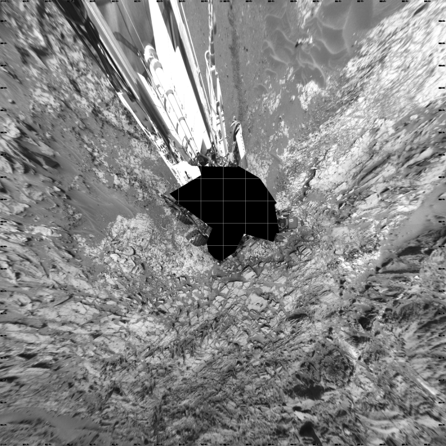 NASA's Mars rover Curiosity took 31 images in Gale Crater using its mast-mounted Left Navigation Camera (Navcam) to create this mosaic. The seam-corrected mosaic provides a vertical projection of the Martian surface near the rover, covering an area of 20 meters (north/south) by 20 meters (east/west). North is up in the image. This projection provides an overhead view, but introduces distortion for items not on the surface, such as large rocks and the rover itself.  Curiosity took the images on May 28, 2015, Sol 997 of the Mars Science Laboratory mission at drive 1570, site number 48. The local mean solar time for the image exposures was 2 PM. Each Navcam image has a 45-degree field of view. CREDIT: NASA/JPL-Caltech