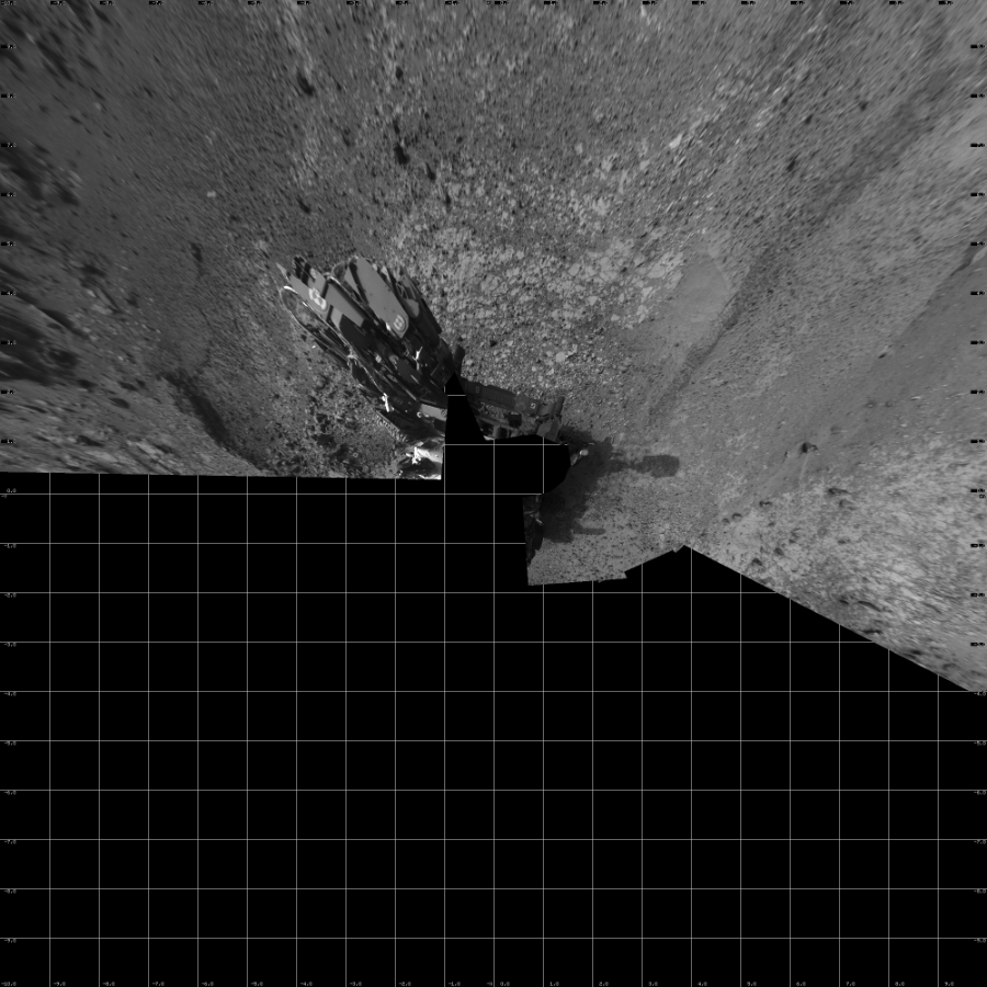 NASA's Mars rover Curiosity took 14 images in Gale Crater using its mast-mounted Left Navigation Camera (Navcam) to create this mosaic. The seam-corrected mosaic provides a vertical projection of the Martian surface near the rover, covering an area of 20 meters (north/south) by 20 meters (east/west). North is up in the image. This projection provides an overhead view, but introduces distortion for items not on the surface, such as large rocks and the rover itself.  Curiosity took the images on July 10, 2015, Sol 1039 of the Mars Science Laboratory mission at drive 1970, site number 48. The local mean solar time for the image exposures was 4 PM. Each Navcam image has a 45-degree field of view. CREDIT: NASA/JPL-Caltech