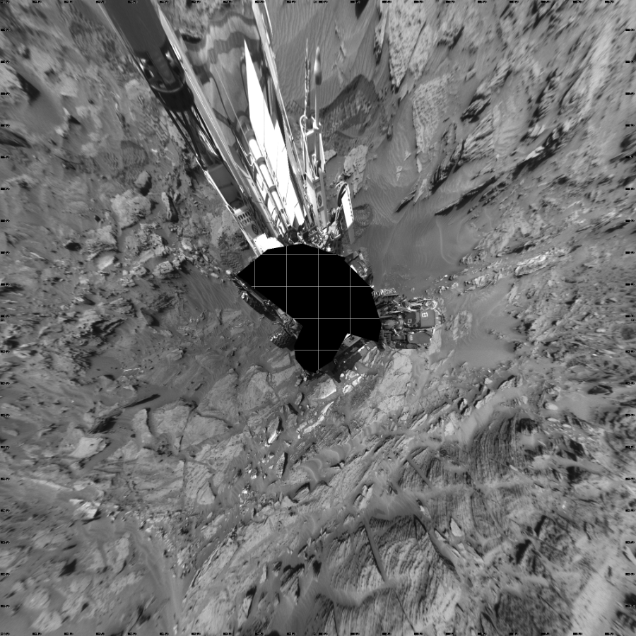NASA's Mars rover Curiosity took 19 images in Gale Crater using its mast-mounted Left Navigation Camera (Navcam) to create this mosaic. The seam-corrected mosaic provides a vertical projection of the Martian surface near the rover, covering an area of 20 meters (north/south) by 20 meters (east/west). North is up in the image. This projection provides an overhead view, but introduces distortion for items not on the surface, such as large rocks and the rover itself.  Curiosity took the images on August 28, 2015, Sol 1087 of the Mars Science Laboratory mission at drive 1876, site number 49. The local mean solar time for the image exposures was from 2 PM to 3 PM. Each Navcam image has a 45-degree field of view. CREDIT: NASA/JPL-Caltech