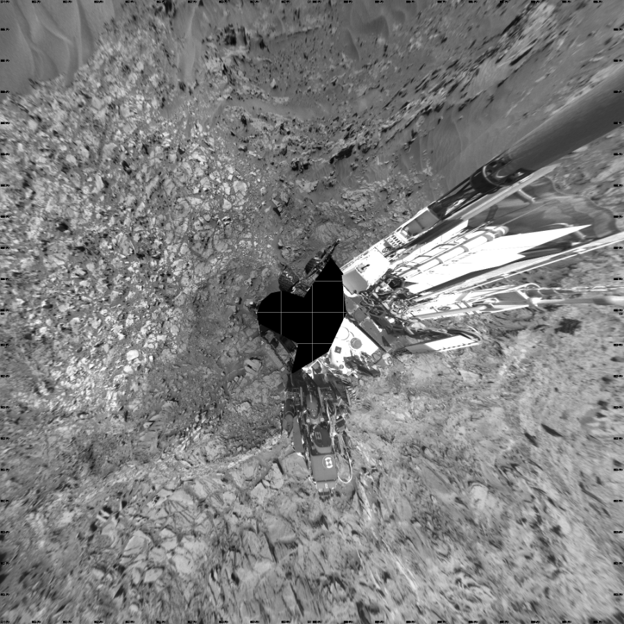 NASA's Mars rover Curiosity took 18 images in Gale Crater using its mast-mounted Left Navigation Camera (Navcam) to create this mosaic. The seam-corrected mosaic provides a vertical projection of the Martian surface near the rover, covering an area of 20 meters (north/south) by 20 meters (east/west). North is up in the image. This projection provides an overhead view, but introduces distortion for items not on the surface, such as large rocks and the rover itself.  Curiosity took the images on September 18, 2015, Sol 1107 of the Mars Science Laboratory mission at drive 250, site number 50. The local mean solar time for the image exposures was 1 PM. Each Navcam image has a 45-degree field of view. CREDIT: NASA/JPL-Caltech