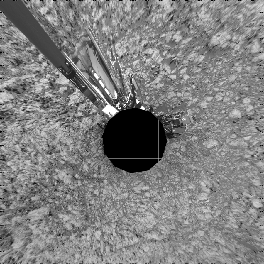 NASA's Mars rover Curiosity took 12 images in Gale Crater using its mast-mounted Left Navigation Camera (Navcam) to create this mosaic. The seam-corrected mosaic provides a vertical projection of the Martian surface near the rover, covering an area of 20 meters (north/south) by 20 meters (east/west). North is up in the image. This projection provides an overhead view, but introduces distortion for items not on the surface, such as large rocks and the rover itself.  Curiosity took the images on November 23, 2015, Sol 1172 of the Mars Science Laboratory mission at drive 592, site number 51. The local mean solar time for the image exposures was 1 PM. Each Navcam image has a 45-degree field of view. CREDIT: NASA/JPL-Caltech