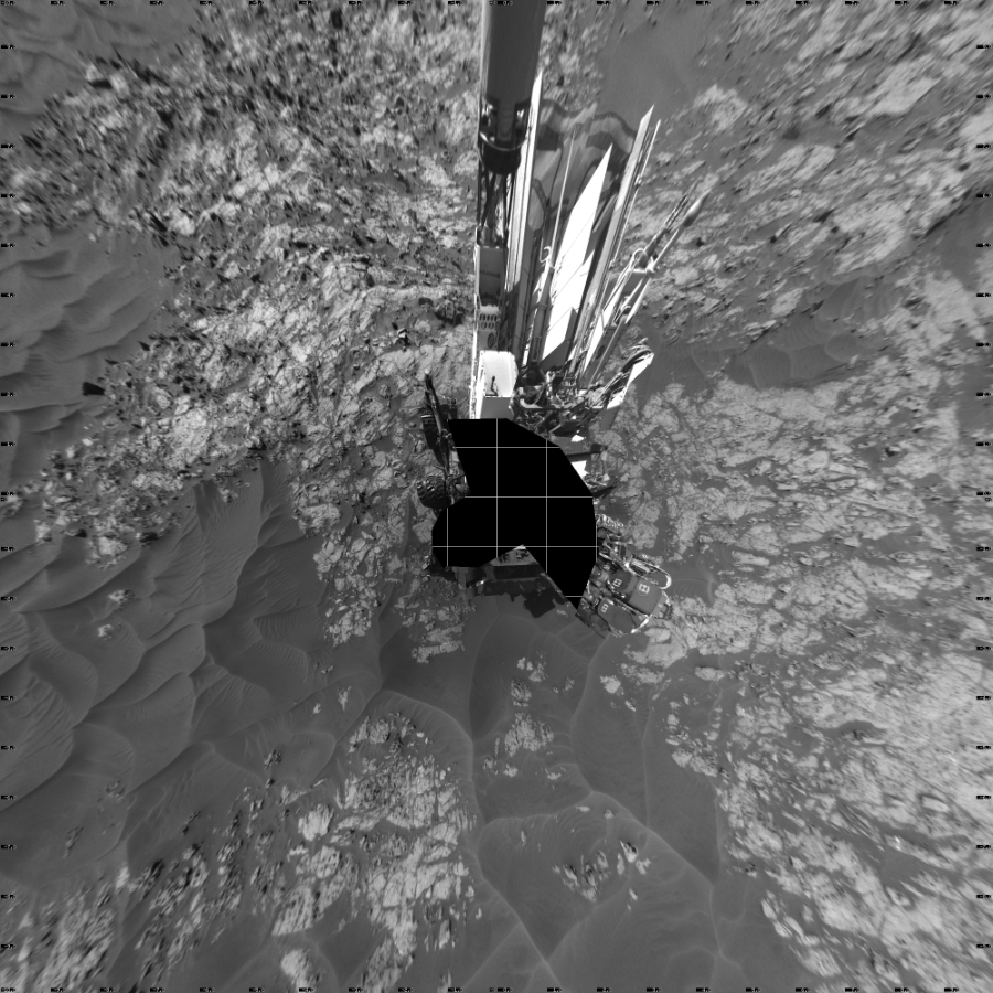 NASA's Mars rover Curiosity took 19 images in Gale Crater using its mast-mounted Left Navigation Camera (Navcam) to create this mosaic. The seam-corrected mosaic provides a vertical projection of the Martian surface near the rover, covering an area of 20 meters (north/south) by 20 meters (east/west). North is up in the image. This projection provides an overhead view, but introduces distortion for items not on the surface, such as large rocks and the rover itself.  Curiosity took the images on November 25, 2015, Sol 1174 of the Mars Science Laboratory mission at drive 1102, site number 51. The local mean solar time for the image exposures was 2 PM. Each Navcam image has a 45-degree field of view. CREDIT: NASA/JPL-Caltech