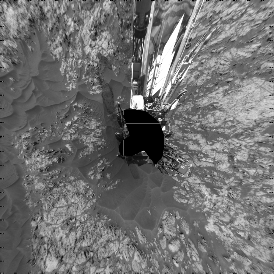 NASA's Mars rover Curiosity took 19 images in Gale Crater using its mast-mounted Left Navigation Camera (Navcam) to create this mosaic. The seam-corrected mosaic provides a vertical projection of the Martian surface near the rover, covering an area of 20 meters (north/south) by 20 meters (east/west). North is up in the image. This projection provides an overhead view, but introduces distortion for items not on the surface, such as large rocks and the rover itself.  Curiosity took the images on December 03, 2015, Sol 1181 of the Mars Science Laboratory mission at drive 1298, site number 51. The local mean solar time for the image exposures was 1 PM. Each Navcam image has a 45-degree field of view. CREDIT: NASA/JPL-Caltech