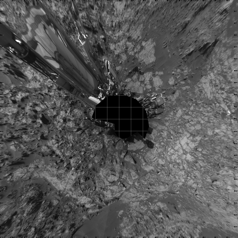 NASA's Mars rover Curiosity took 17 images in Gale Crater using its mast-mounted Left Navigation Camera (Navcam) to create this mosaic. The seam-corrected mosaic provides a vertical projection of the Martian surface near the rover, covering an area of 20 meters (north/south) by 20 meters (east/west). North is up in the image. This projection provides an overhead view, but introduces distortion for items not on the surface, such as large rocks and the rover itself.  Curiosity took the images on December 07, 2015, Sol 1185 of the Mars Science Laboratory mission at drive 1800, site number 51. The local mean solar time for the image exposures was 3 PM. Each Navcam image has a 45-degree field of view. CREDIT: NASA/JPL-Caltech