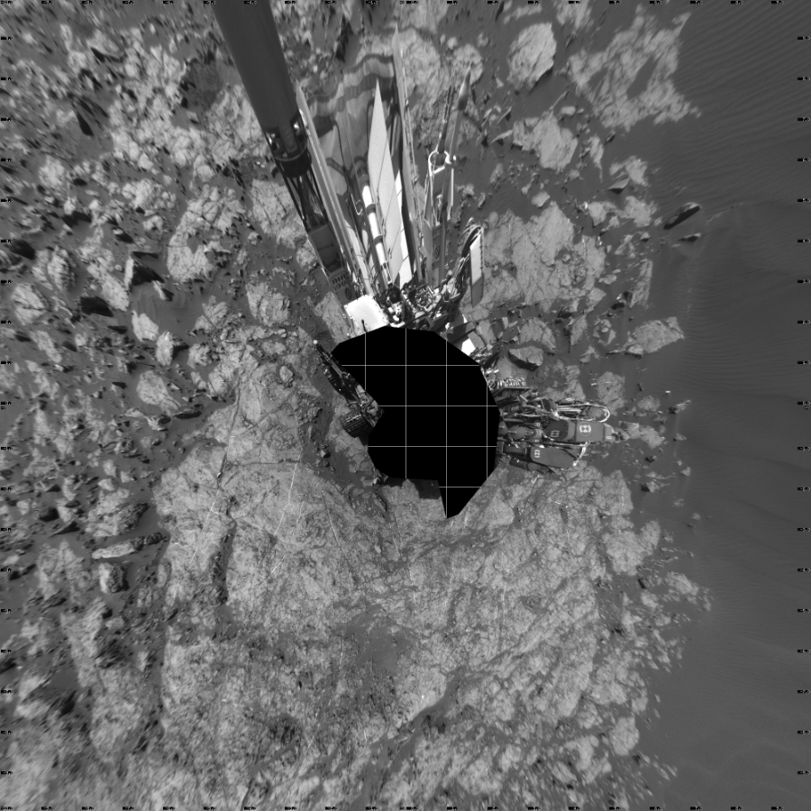 NASA's Mars rover Curiosity took 17 images in Gale Crater using its mast-mounted Left Navigation Camera (Navcam) to create this mosaic. The seam-corrected mosaic provides a vertical projection of the Martian surface near the rover, covering an area of 20 meters (north/south) by 20 meters (east/west). North is up in the image. This projection provides an overhead view, but introduces distortion for items not on the surface, such as large rocks and the rover itself.  Curiosity took the images on December 14, 2015, Sol 1192 of the Mars Science Laboratory mission at drive 2322, site number 51. The local mean solar time for the image exposures was 1 PM. Each Navcam image has a 45-degree field of view. CREDIT: NASA/JPL-Caltech