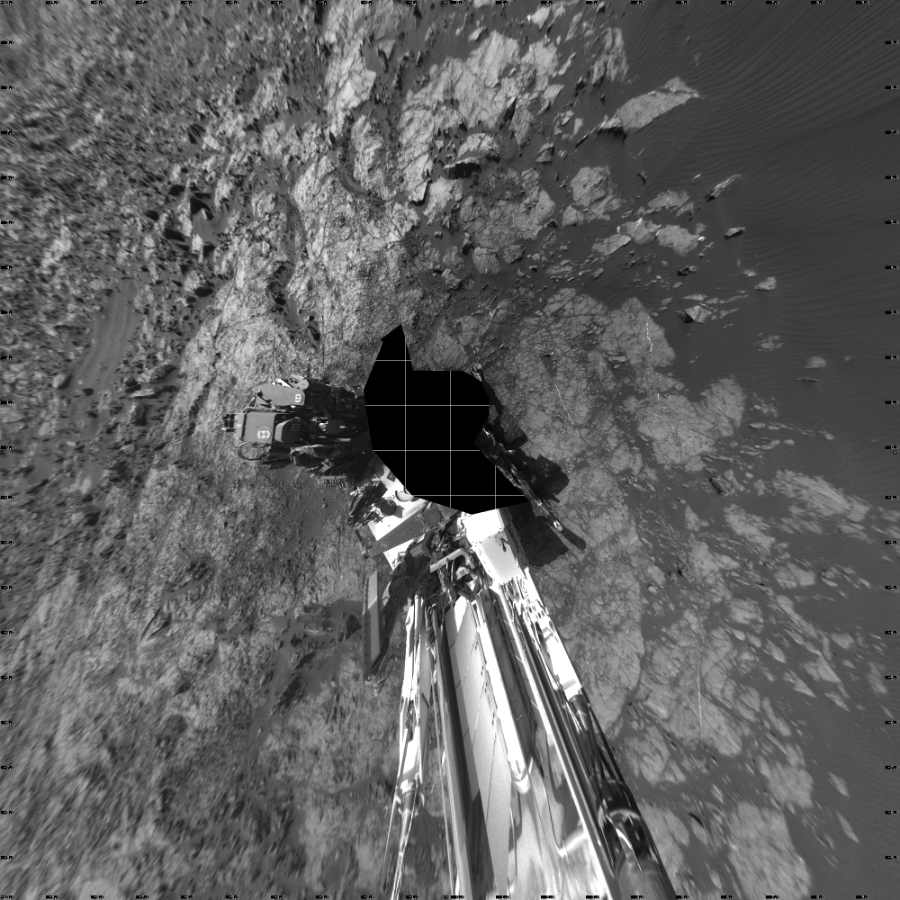 NASA's Mars rover Curiosity took 17 images in Gale Crater using its mast-mounted Left Navigation Camera (Navcam) to create this mosaic. The seam-corrected mosaic provides a vertical projection of the Martian surface near the rover, covering an area of 20 meters (north/south) by 20 meters (east/west). North is up in the image. This projection provides an overhead view, but introduces distortion for items not on the surface, such as large rocks and the rover itself. Curiosity took the images on January 07, 2016, Sol 1215 of the Mars Science Laboratory mission at drive 614, site number 52. The local mean solar time for the image exposures was 2 PM. Each Navcam image has a 45-degree field of view. CREDIT: NASA/JPL-Caltech