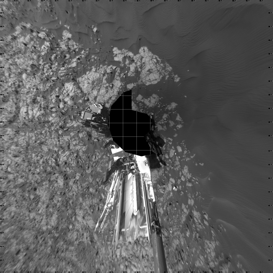 NASA's Mars rover Curiosity took 21 images in Gale Crater using its mast-mounted Left Navigation Camera (Navcam) to create this mosaic. The seam-corrected mosaic provides a vertical projection of the Martian surface near the rover, covering an area of 20 meters (north/south) by 20 meters (east/west). North is up in the image. This projection provides an overhead view, but introduces distortion for items not on the surface, such as large rocks and the rover itself.  Curiosity took the images on January 08, 2016, Sol 1216 of the Mars Science Laboratory mission at drive 936, site number 52. The local mean solar time for the image exposures was 2 PM. Each Navcam image has a 45-degree field of view. CREDIT: NASA/JPL-Caltech