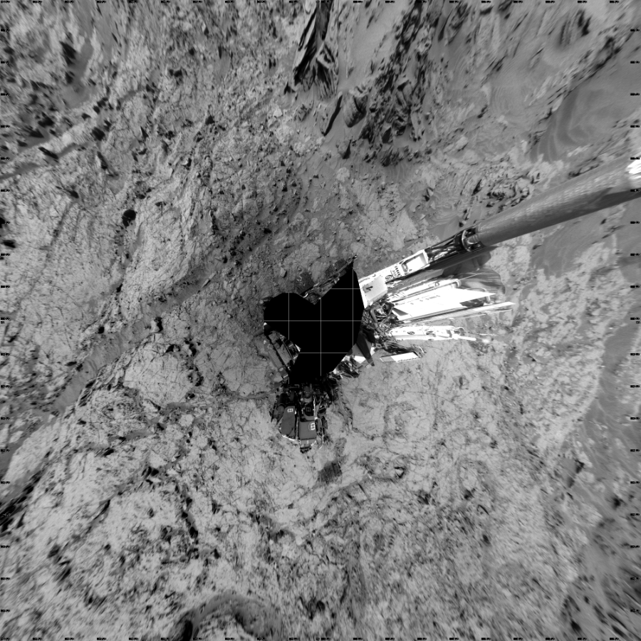 NASA's Mars rover Curiosity took 18 images in Gale Crater using its mast-mounted Left Navigation Camera (Navcam) to create this mosaic. The seam-corrected mosaic provides a vertical projection of the Martian surface near the rover, covering an area of 20 meters (north/south) by 20 meters (east/west). North is up in the image. This projection provides an overhead view, but introduces distortion for items not on the surface, such as large rocks and the rover itself.  Curiosity took the images on May 27, 2016, Sol 1353 of the Mars Science Laboratory mission at drive 2202, site number 54. The local mean solar time for the image exposures was from 1 PM to 2 PM. Each Navcam image has a 45-degree field of view. CREDIT: NASA/JPL-Caltech