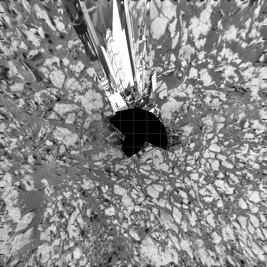 NASA's Mars rover Curiosity took 27 images in Gale Crater using its mast-mounted Left Navigation Camera (Navcam) to create this mosaic. The seam-corrected mosaic provides a vertical projection of the Martian surface near the rover, covering an area of 20 meters (north/south) by 20 meters (east/west). North is up in the image. This projection provides an overhead view, but introduces distortion for items not on the surface, such as large rocks and the rover itself.  Curiosity took the images on August 23, 2016, Sol 1438 of the Mars Science Laboratory mission at drive 774, site number 57. The local mean solar time for the image exposures was 12 PM. Each Navcam image has a 45-degree field of view. CREDIT: NASA/JPL-Caltech