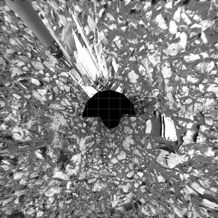 NASA's Mars rover Curiosity took 17 images in Gale Crater using its mast-mounted Left Navigation Camera (Navcam) to create this mosaic. The seam-corrected mosaic provides a vertical projection of the Martian surface near the rover, covering an area of 20 meters (north/south) by 20 meters (east/west). North is up in the image. This projection provides an overhead view, but introduces distortion for items not on the surface, such as large rocks and the rover itself.  Curiosity took the images on October 27, 2016, Sol 1502 of the Mars Science Laboratory mission at drive 2946, site number 58. The local mean solar time for the image exposures was from 1 PM to 2 PM. Each Navcam image has a 45-degree field of view. CREDIT: NASA/JPL-Caltech