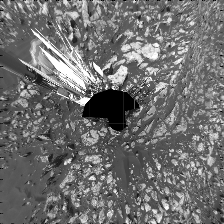 NASA's Mars rover Curiosity took 18 images in Gale Crater using its mast-mounted Left Navigation Camera (Navcam) to create this mosaic. The seam-corrected mosaic provides a vertical projection of the Martian surface near the rover, covering an area of 20 meters (north/south) by 20 meters (east/west). North is up in the image. This projection provides an overhead view, but introduces distortion for items not on the surface, such as large rocks and the rover itself.  Curiosity took the images on November 16, 2016, Sol 1521 of the Mars Science Laboratory mission at drive 2668, site number 59. The local mean solar time for the image exposures was 2 PM. Each Navcam image has a 45-degree field of view. CREDIT: NASA/JPL-Caltech