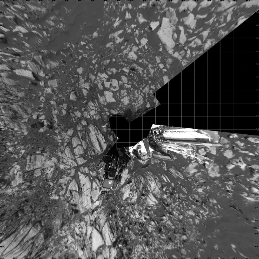 NASA's Mars rover Curiosity took 17 images in Gale Crater using its mast-mounted Left Navigation Camera (Navcam) to create this mosaic. The seam-corrected mosaic provides a vertical projection of the Martian surface near the rover, covering an area of 20 meters (north/south) by 20 meters (east/west). North is up in the image. This projection provides an overhead view, but introduces distortion for items not on the surface, such as large rocks and the rover itself.  Curiosity took the images on February 13, 2017, Sol 1608 of the Mars Science Laboratory mission at drive 252, site number 61. The local mean solar time for the image exposures was 2 PM. Each Navcam image has a 45-degree field of view. CREDIT: NASA/JPL-Caltech