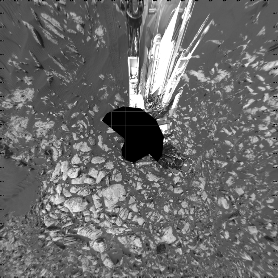 NASA's Mars rover Curiosity took 17 images in Gale Crater using its mast-mounted Left Navigation Camera (Navcam) to create this mosaic. The seam-corrected mosaic provides a vertical projection of the Martian surface near the rover, covering an area of 20 meters (north/south) by 20 meters (east/west). North is up in the image. This projection provides an overhead view, but introduces distortion for items not on the surface, such as large rocks and the rover itself.  Curiosity took the images on February 15, 2017, Sol 1610 of the Mars Science Laboratory mission at drive 456, site number 61. The local mean solar time for the image exposures was from 2 PM to 3 PM. Each Navcam image has a 45-degree field of view. CREDIT: NASA/JPL-Caltech