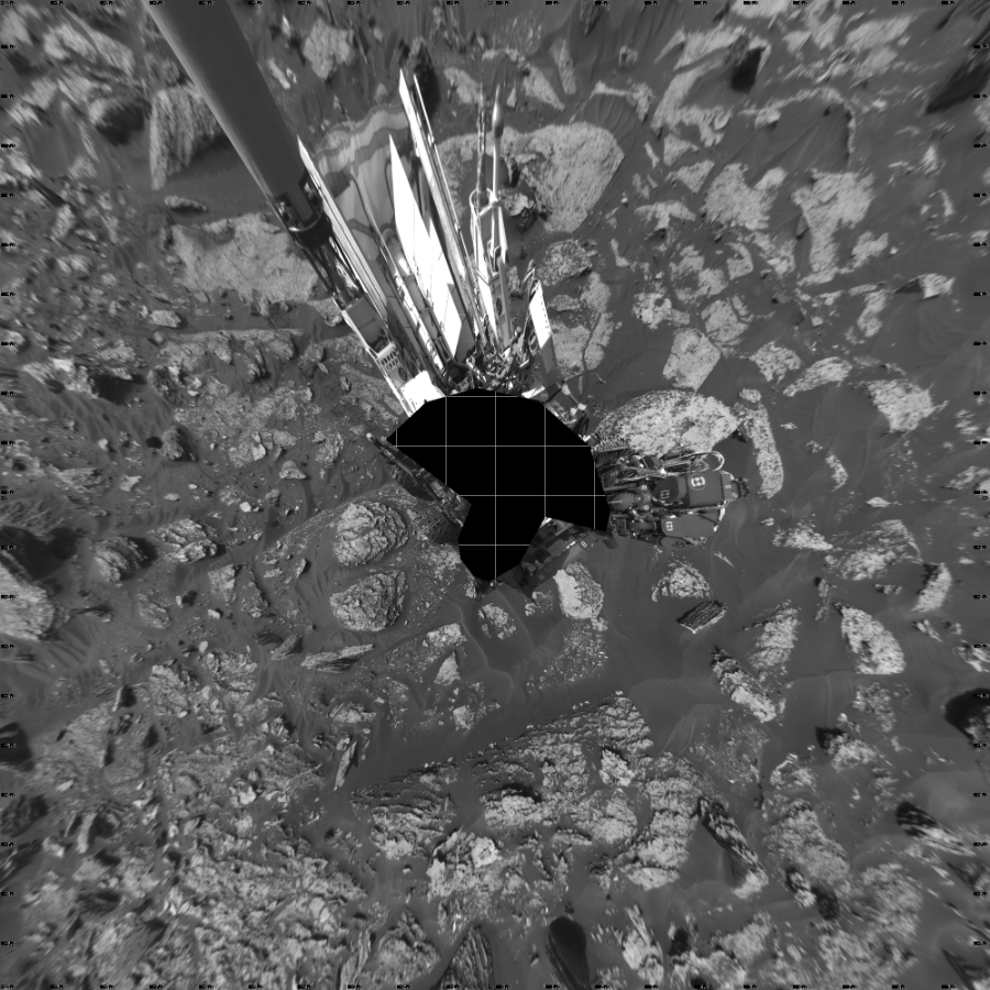 NASA's Mars rover Curiosity took 19 images in Gale Crater using its mast-mounted Left Navigation Camera (Navcam) to create this mosaic. The seam-corrected mosaic provides a vertical projection of the Martian surface near the rover, covering an area of 20 meters (north/south) by 20 meters (east/west). North is up in the image. This projection provides an overhead view, but introduces distortion for items not on the surface, such as large rocks and the rover itself.  Curiosity took the images on May 19, 2017, Sol 1700 of the Mars Science Laboratory mission at drive 1420, site number 63. The local mean solar time for the image exposures was from 2 PM to 4 PM. Each Navcam image has a 45-degree field of view. CREDIT: NASA/JPL-Caltech