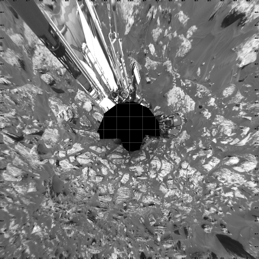 NASA's Mars rover Curiosity took 17 images in Gale Crater using its mast-mounted Left Navigation Camera (Navcam) to create this mosaic. The seam-corrected mosaic provides a vertical projection of the Martian surface near the rover, covering an area of 20 meters (north/south) by 20 meters (east/west). North is up in the image. This projection provides an overhead view, but introduces distortion for items not on the surface, such as large rocks and the rover itself. Curiosity took the images on June 05, 2017, Sol 1717 of the Mars Science Laboratory mission at drive 2372, site number 63. The local mean solar time for the image exposures was 1 PM. Each Navcam image has a 45-degree field of view. CREDIT: NASA/JPL-Caltech