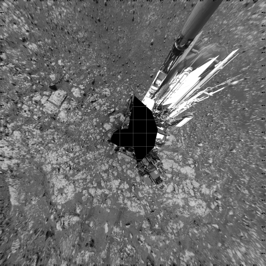 NASA's Mars rover Curiosity took 19 images in Gale Crater using its mast-mounted Left Navigation Camera (Navcam) to create this mosaic. The seam-corrected mosaic provides a vertical projection of the Martian surface near the rover, covering an area of 20 meters (north/south) by 20 meters (east/west). North is up in the image. This projection provides an overhead view, but introduces distortion for items not on the surface, such as large rocks and the rover itself.  Curiosity took the images on March 26, 2018, Sol 2003 of the Mars Science Laboratory mission at drive 0, site number 69. The local mean solar time for the image exposures was 2 PM. Each Navcam image has a 45-degree field of view. CREDIT: NASA/JPL-Caltech