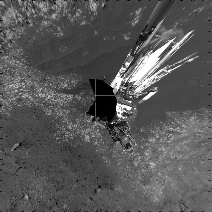 NASA's Mars rover Curiosity took 18 images in Gale Crater using its mast-mounted Left Navigation Camera (Navcam) to create this mosaic. The seam-corrected mosaic provides a vertical projection of the Martian surface near the rover, covering an area of 20 meters (north/south) by 20 meters (east/west). North is up in the image. This projection provides an overhead view, but introduces distortion for items not on the surface, such as large rocks and the rover itself.  Curiosity took the images on April 04, 2018, Sol 2012 of the Mars Science Laboratory mission at drive 1384, site number 69. The local mean solar time for the image exposures was 2 PM. Each Navcam image has a 45-degree field of view. CREDIT: NASA/JPL-Caltech