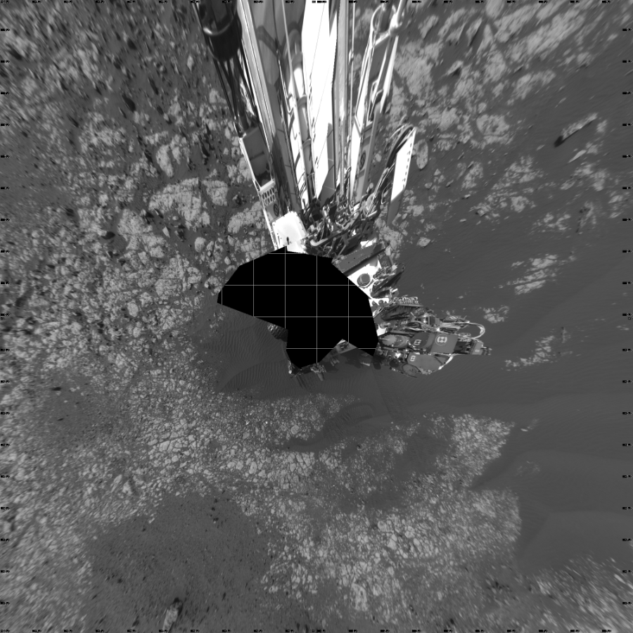 NASA's Mars rover Curiosity took 18 images in Gale Crater using its mast-mounted Left Navigation Camera (Navcam) to create this mosaic. The seam-corrected mosaic provides a vertical projection of the Martian surface near the rover, covering an area of 20 meters (north/south) by 20 meters (east/west). North is up in the image. This projection provides an overhead view, but introduces distortion for items not on the surface, such as large rocks and the rover itself.  Curiosity took the images on April 16, 2018, Sol 2023 of the Mars Science Laboratory mission at drive 1858, site number 69. The local mean solar time for the image exposures was from 2 PM to 4 PM. Each Navcam image has a 45-degree field of view. CREDIT: NASA/JPL-Caltech