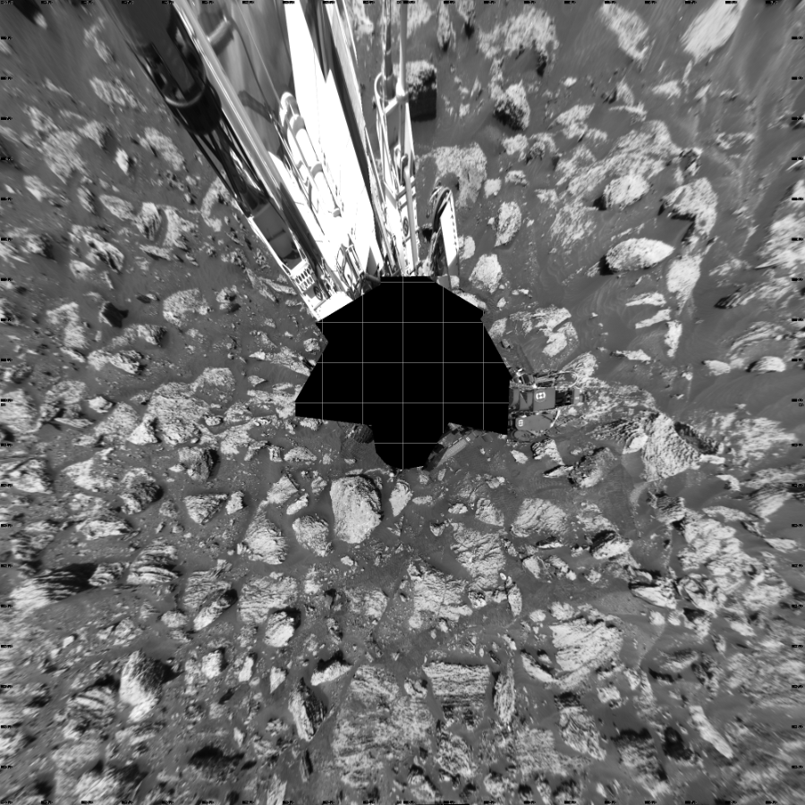 NASA's Mars rover Curiosity took 17 images in Gale Crater using its mast-mounted Left Navigation Camera (Navcam) to create this mosaic. The seam-corrected mosaic provides a vertical projection of the Martian surface near the rover, covering an area of 20 meters (north/south) by 20 meters (east/west). North is up in the image. This projection provides an overhead view, but introduces distortion for items not on the surface, such as large rocks and the rover itself.  Curiosity took the images on May 15, 2018, Sol 2051 of the Mars Science Laboratory mission at drive 1554, site number 70. The local mean solar time for the image exposures was 1 PM. Each Navcam image has a 45-degree field of view. CREDIT: NASA/JPL-Caltech