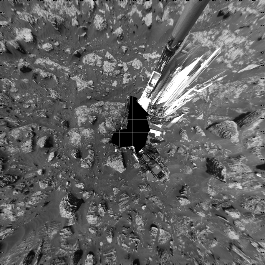 NASA's Mars rover Curiosity took 22 images in Gale Crater using its mast-mounted Left Navigation Camera (Navcam) to create this mosaic. The seam-corrected mosaic provides a vertical projection of the Martian surface near the rover, covering an area of 20 meters (north/south) by 20 meters (east/west). North is up in the image. This projection provides an overhead view, but introduces distortion for items not on the surface, such as large rocks and the rover itself.  Curiosity took the images on May 21, 2018, Sols 2057-2056 of the Mars Science Laboratory mission at drive 1752, site number 70. The local mean solar time for the image exposures was 2 PM. Each Navcam image has a 45-degree field of view. CREDIT: NASA/JPL-Caltech
