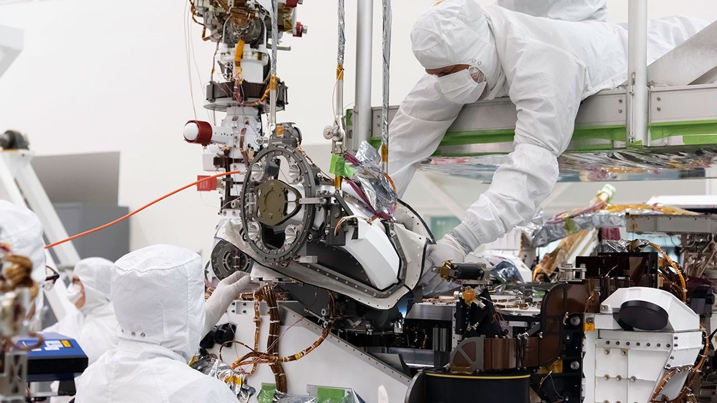 In this August 5, 2019 image, the bit carousel - the heart of sampling and caching subsystem of NASA’s Mars 2020 mission - is attached to the front end of the rover.