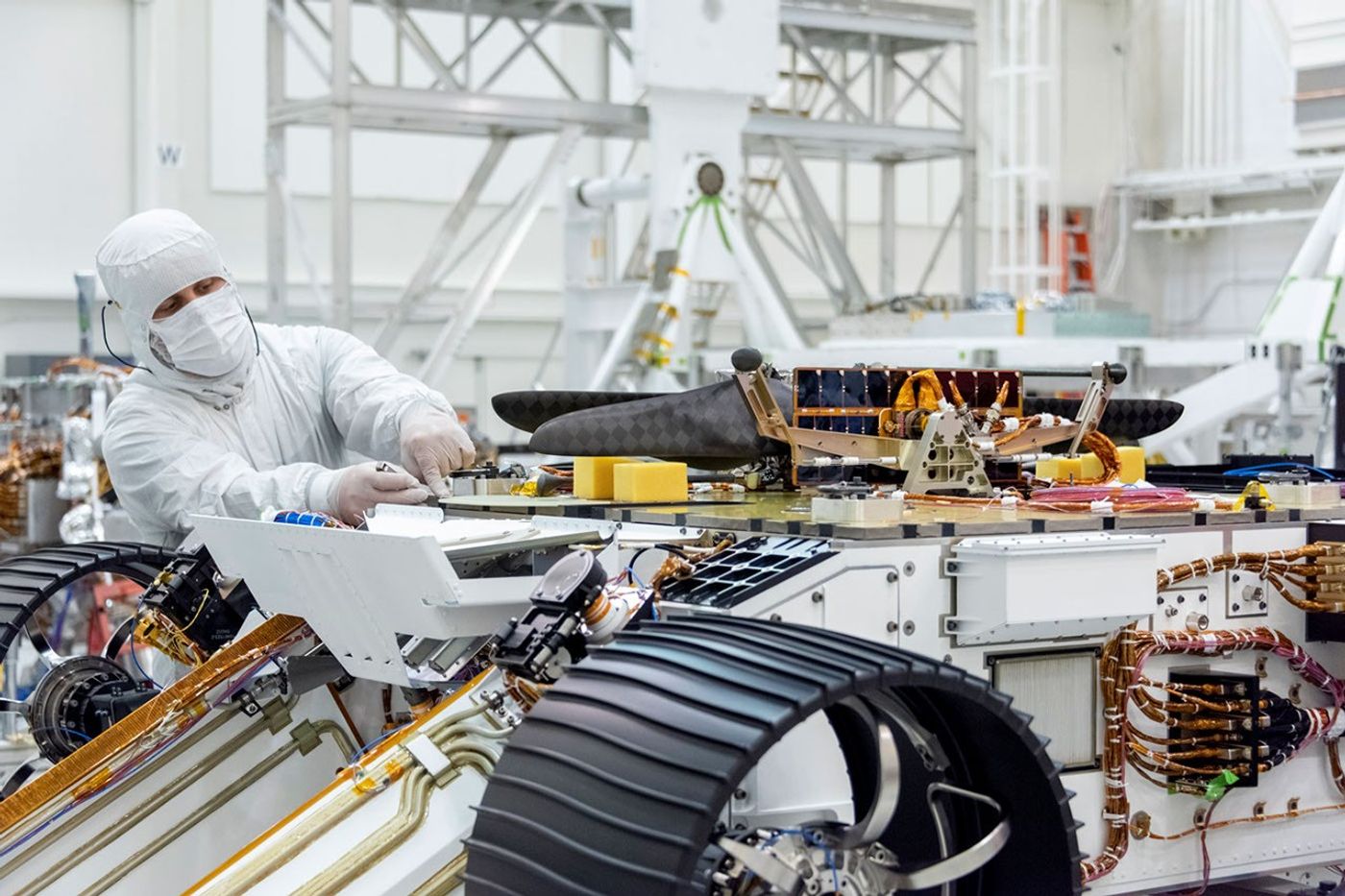 Engineers attached NASA's Mars Helicopter to the belly of the Mars 2020 rover on Aug. 27, 2019, at the Jet Propulsion Laboratory in Pasadena, California.