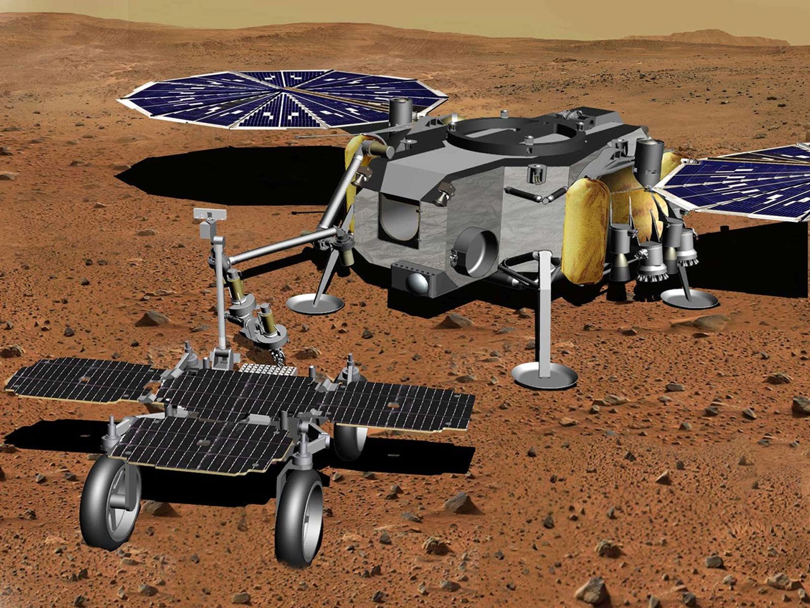 In this illustration of a Mars sample return mission concept, a robotic arm transfers samples of Martian rock and soil from a fetch rover onto a lander.