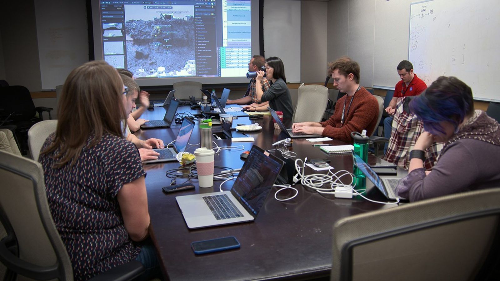 A group of scientists in a conference room