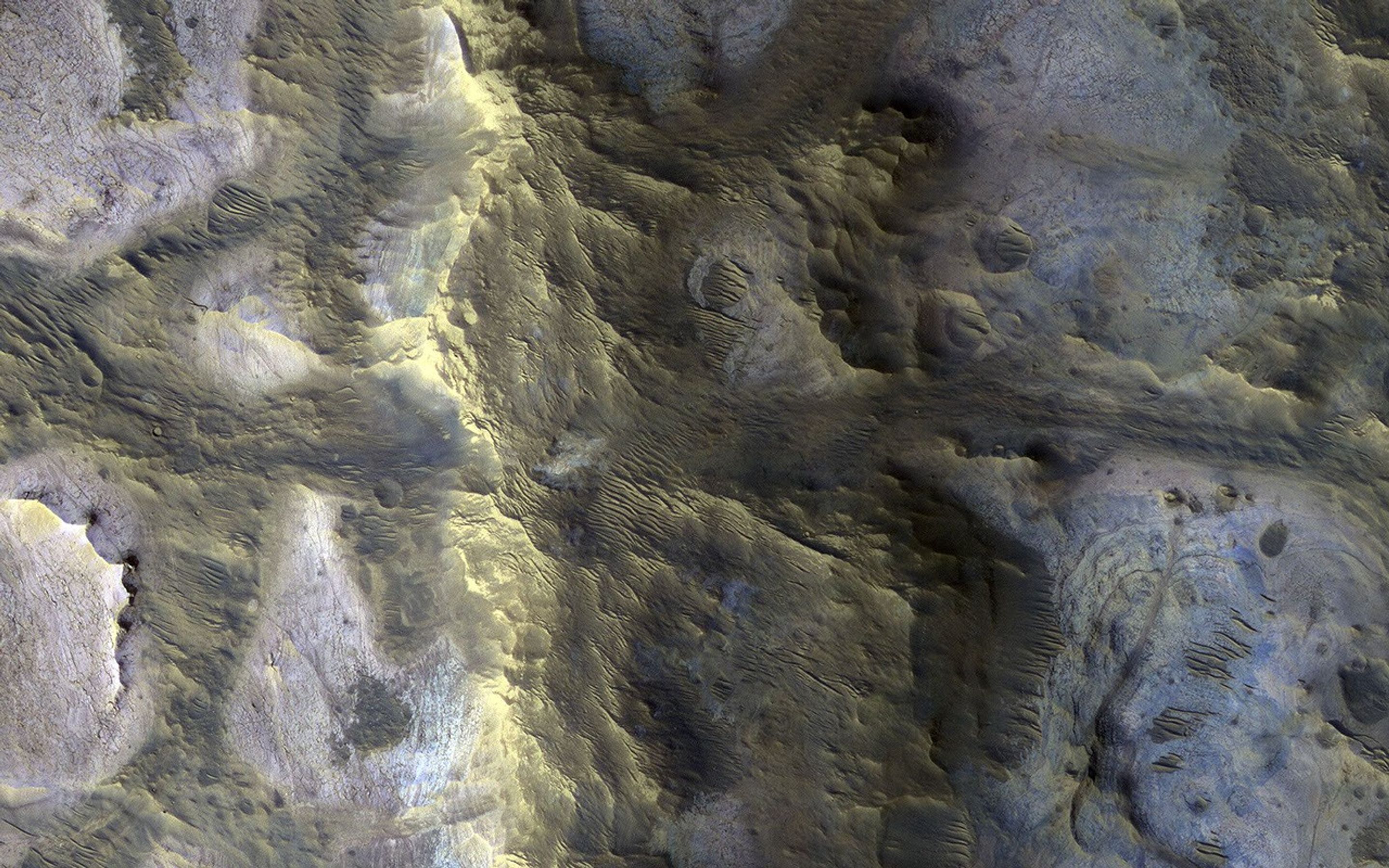 This image acquired on October 12, 2020 by NASAs Mars Reconnaissance Orbiter, shows an isolated, elongated mound (about 1 mile wide and 3.75 miles long) rising above the smooth, surrounding plains.